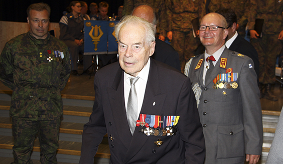 Tuomas Gerdt i Reservofficersskolans Manege. Bakom sig har han militärpersonal och officersaspiranter.