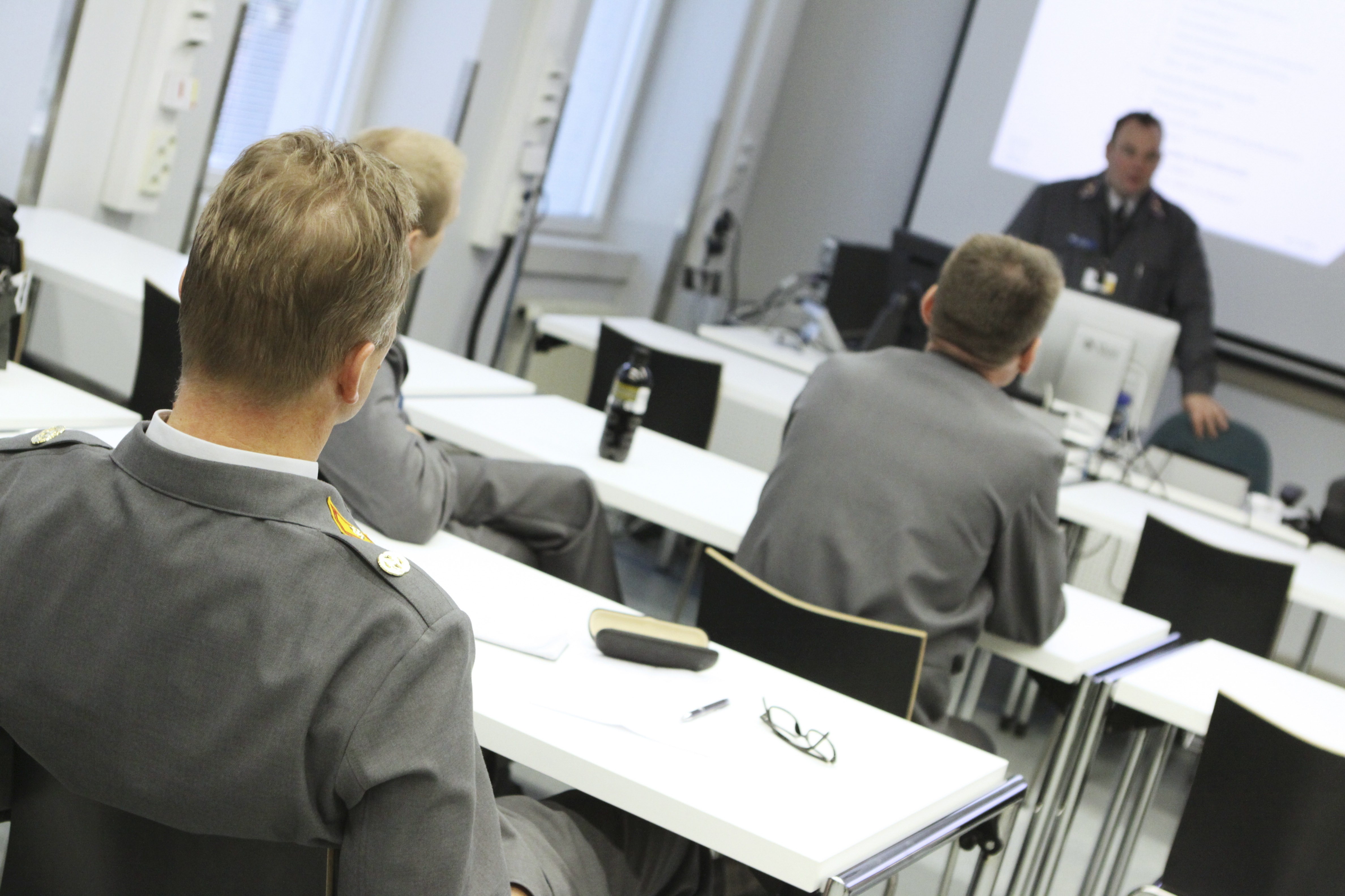 Cadets sitting in a teaching room with their backs to the camera