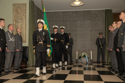 Soldater står på plats medan de bär mästarens flagga.