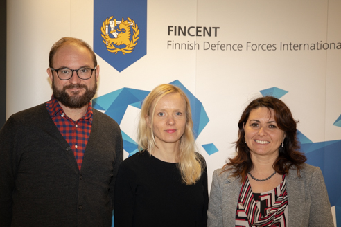 One man and two women posing in front of a Fincent logo