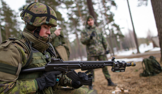 A fighter putting a magazine into an assault rifle